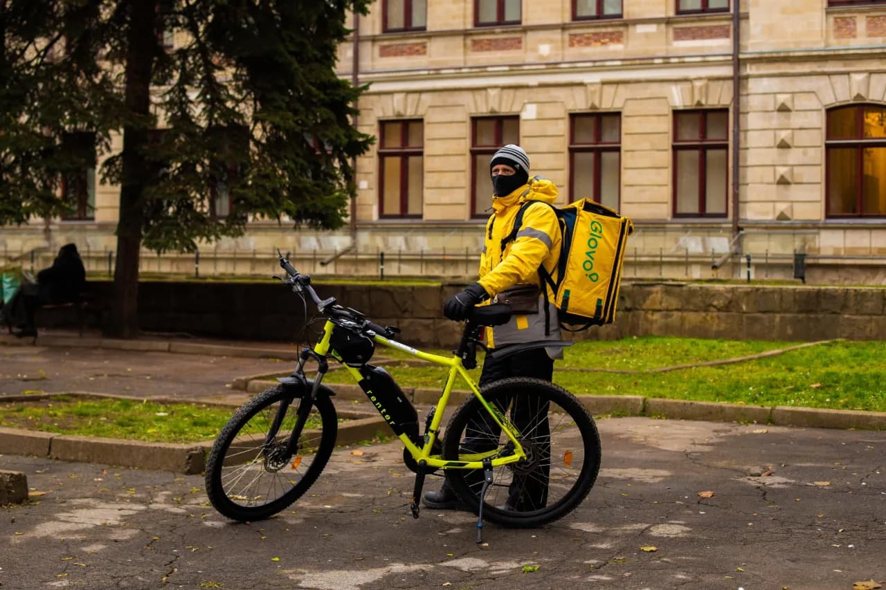 A person riding a bike on a sidewalk