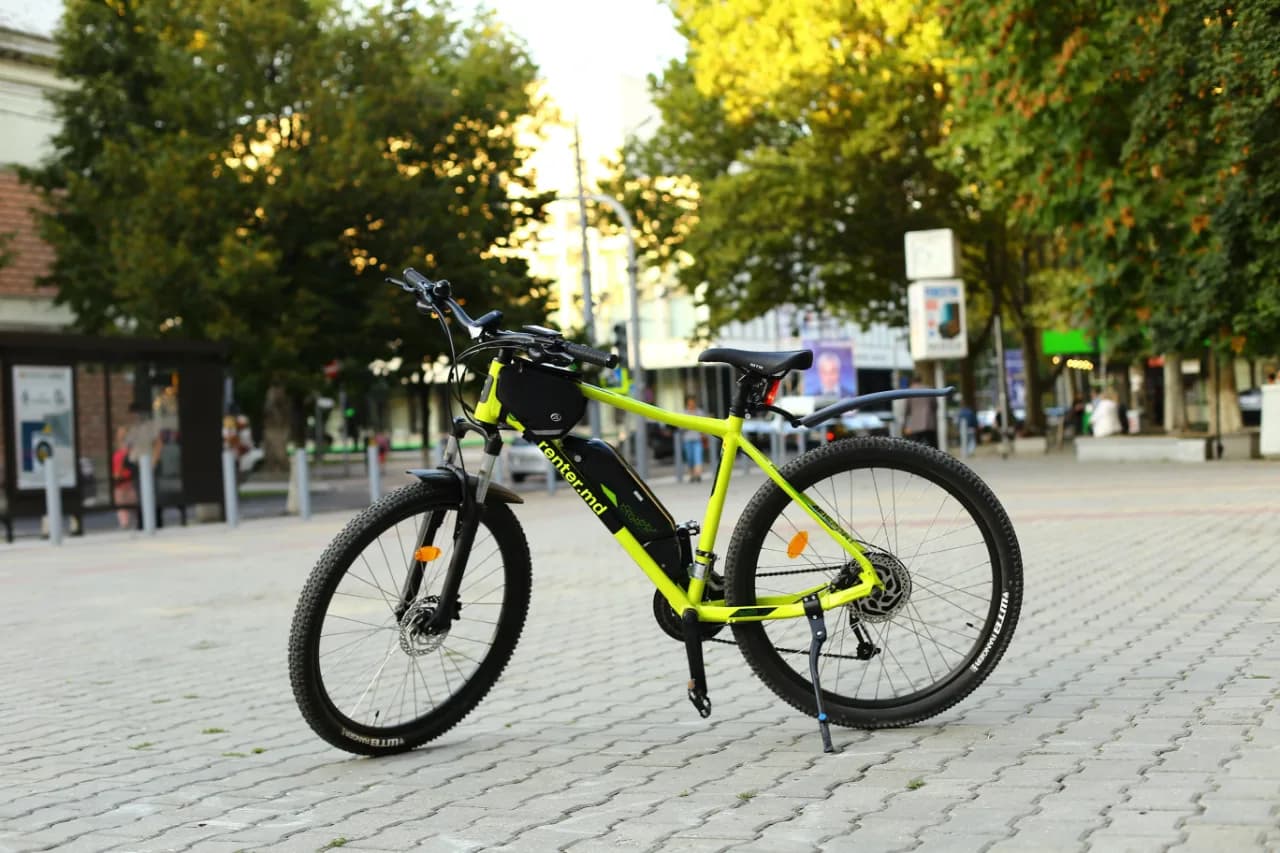 A person riding a bike on a sidewalk