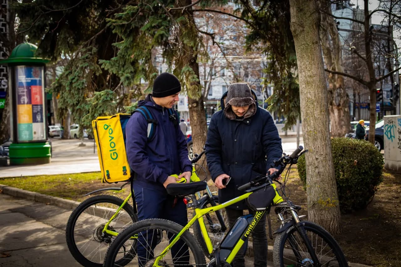 A man and woman standing next to a bike