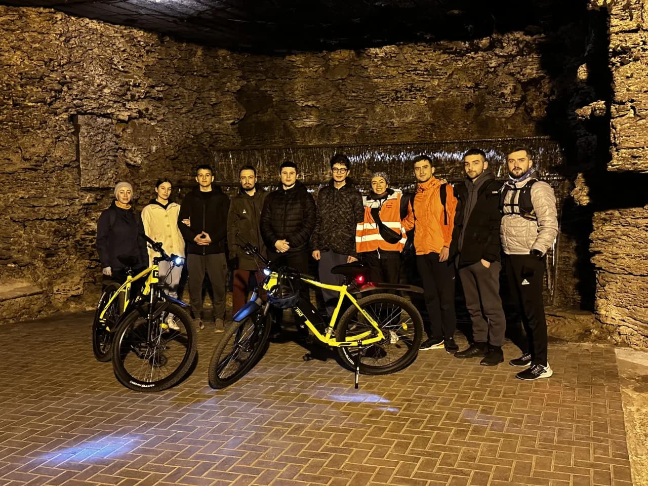 A crowd of people standing around a bike